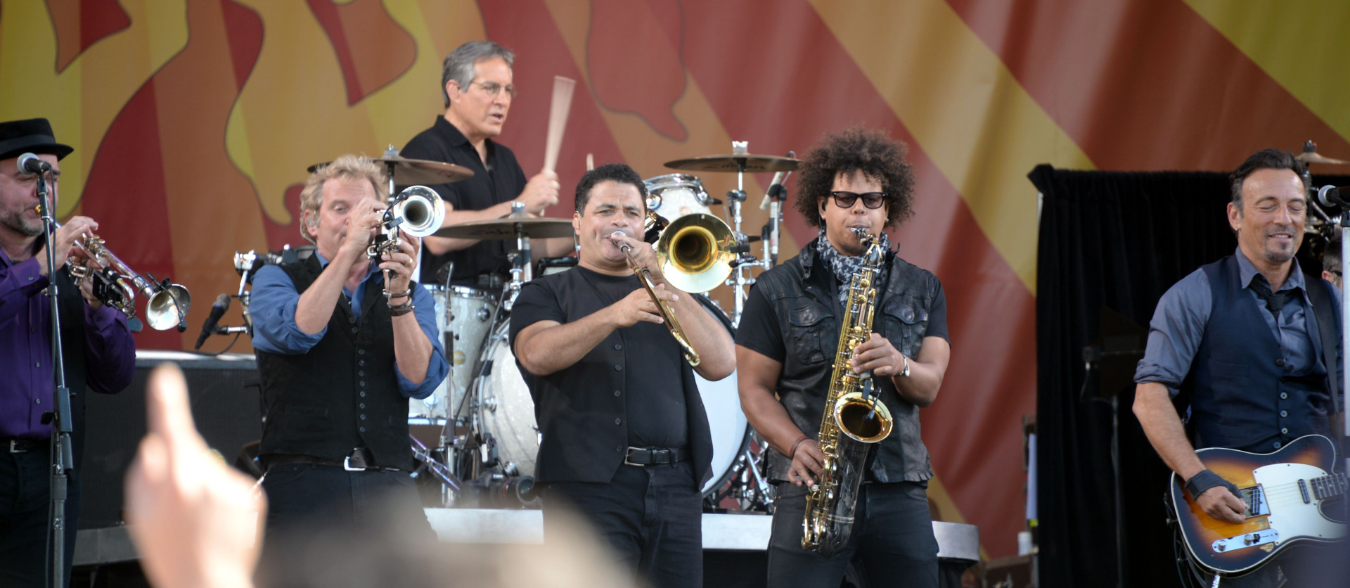 Max Weinberg on drums, fronted by the E Street horns, and Bruce